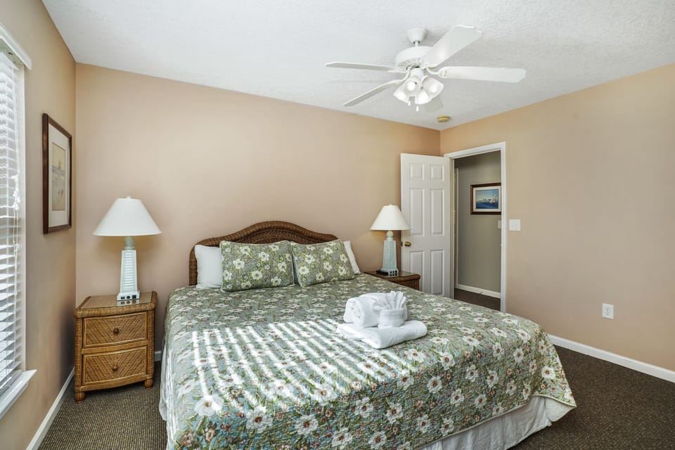 Unwind in your peaceful bedroom with tropical touches, soft linens, and a gentle ceiling fan for ultimate comfort.