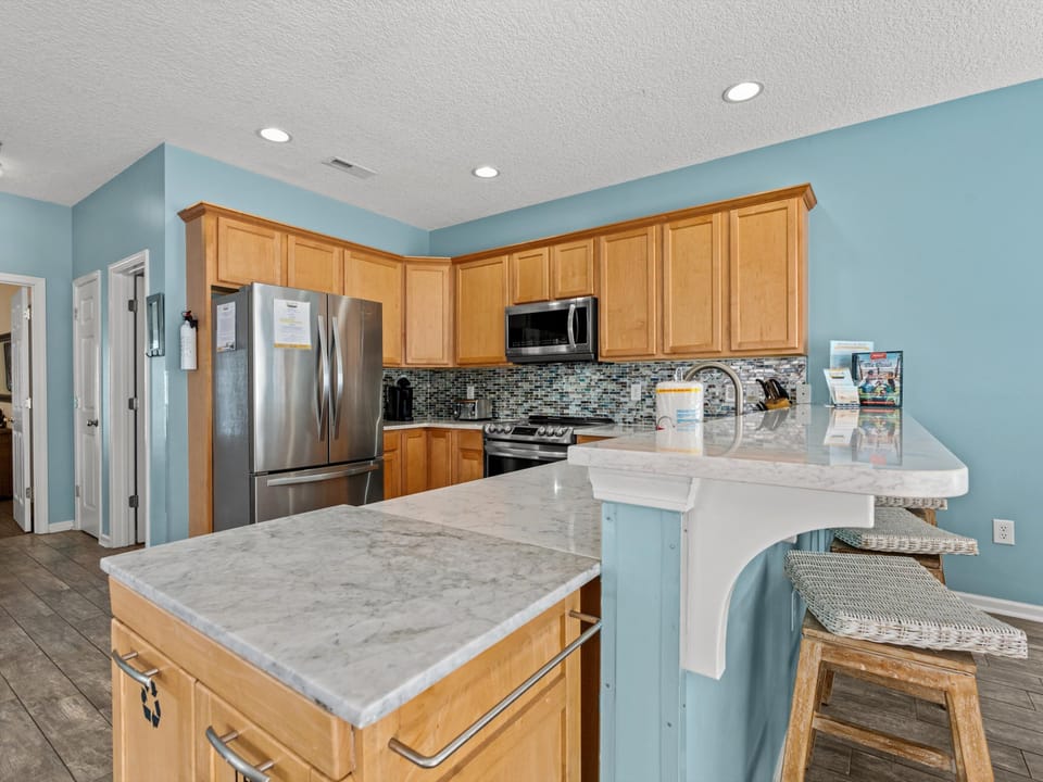 Your spacious kitchen features granite counters, stainless appliances, and a breakfast bar perfect for morning coffee.