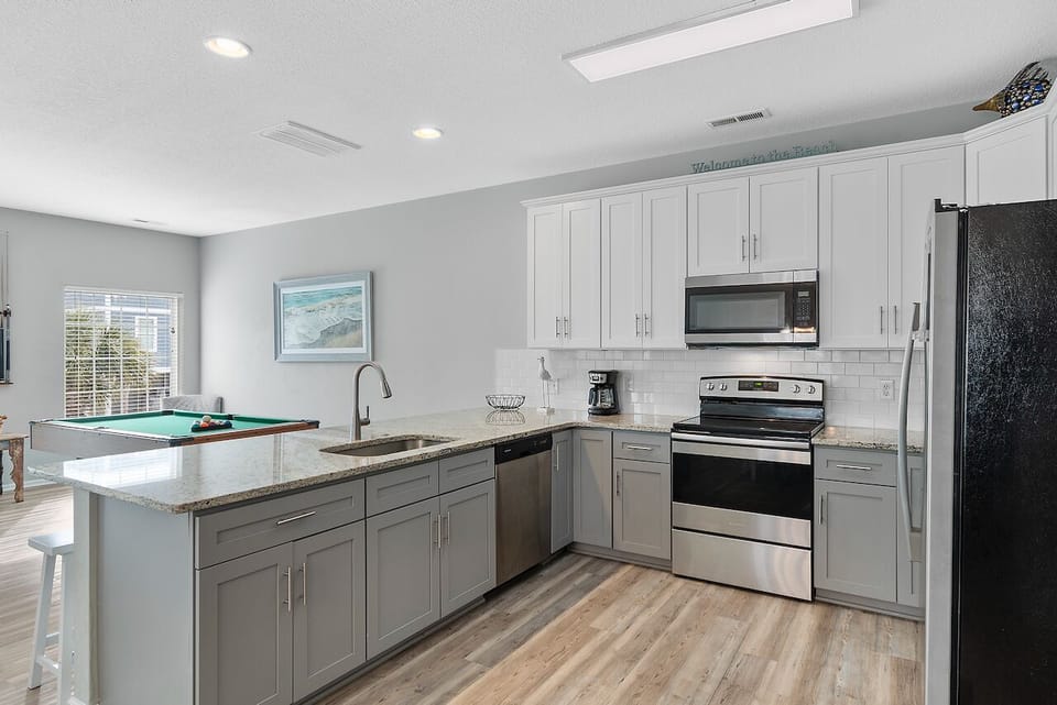 Your fully equipped kitchen features granite countertops, stainless steel appliances, and a breakfast bar perfect for morning coffee or evening cocktails.