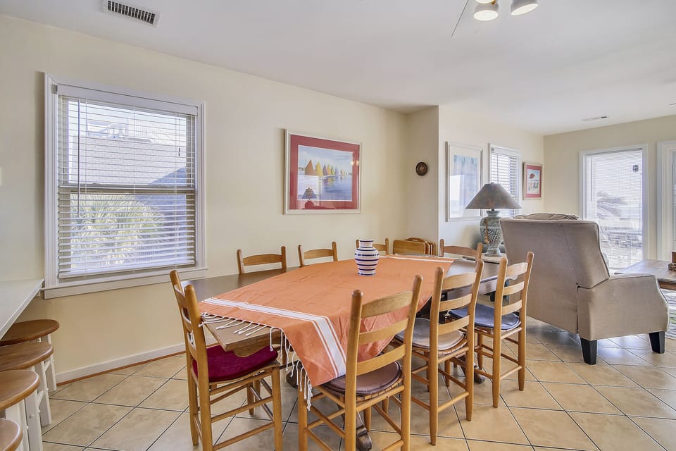 Gather around your spacious dining table where warm conversations flow as freely as the natural light streaming through windows.