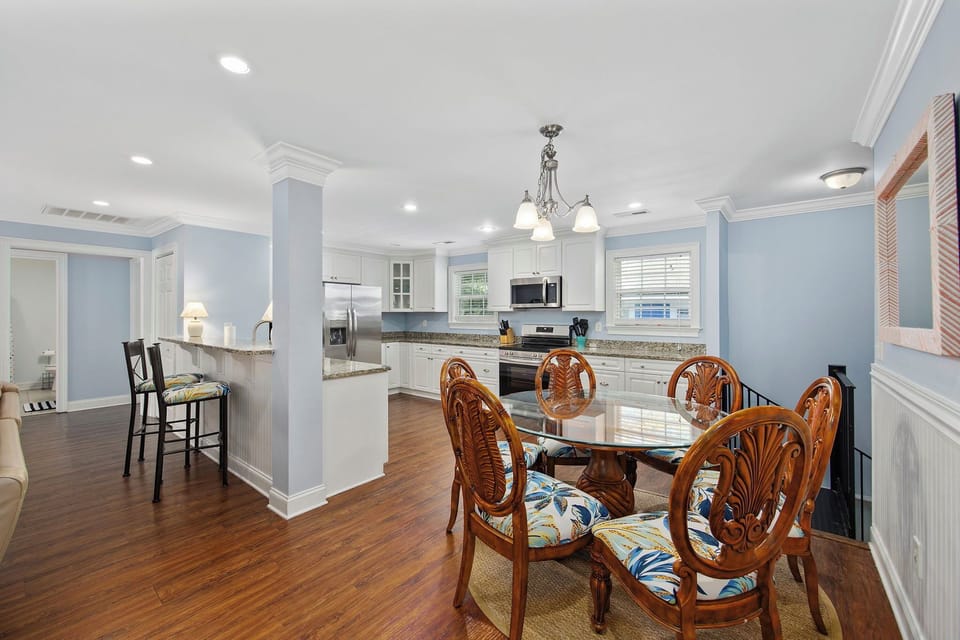 Your elegant dining space flows seamlessly into the fully-equipped kitchen, creating the perfect setting for memorable meals together.