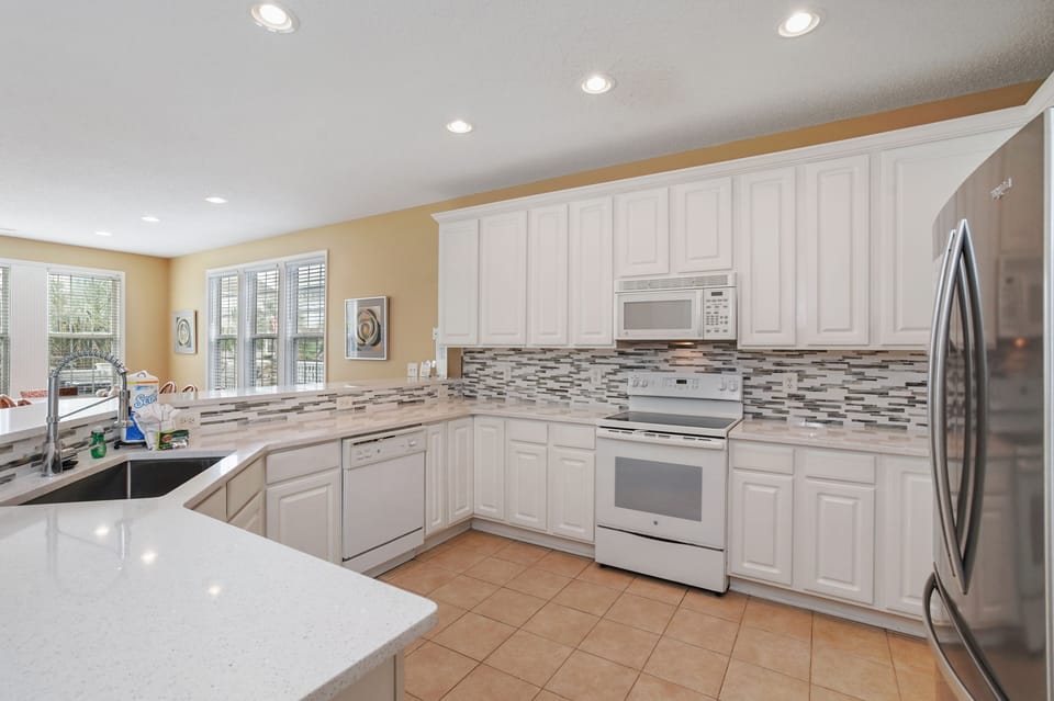 Your spacious kitchen features white cabinets, granite counters, and stainless steel appliances for memorable cooking experiences.