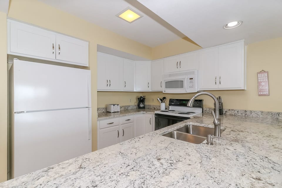 Your fully equipped kitchen features granite countertops, stainless steel appliances, and everything you need to prepare memorable meals during your stay.