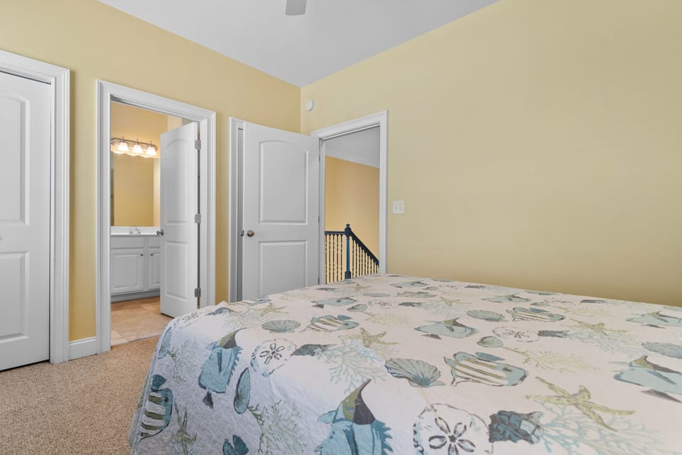 Drift off in your cozy bedroom with soft nautical bedding and convenient ensuite access for ultimate comfort.