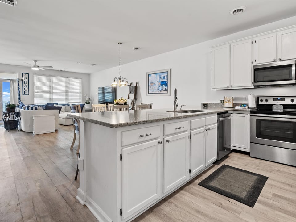 Your spacious open-concept kitchen flows seamlessly into the living area, perfect for cooking and entertaining together.