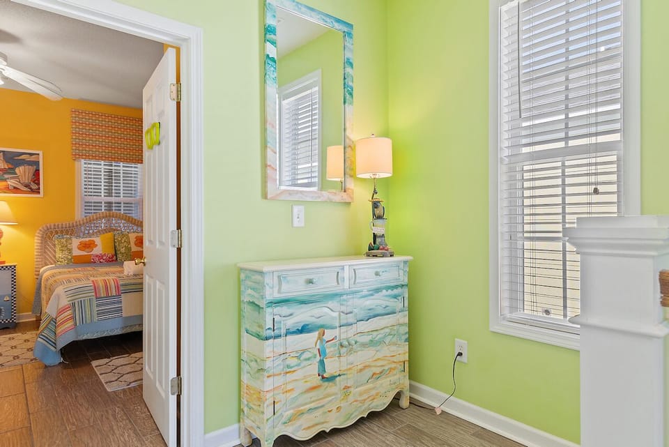 Your colorful retreat features vibrant lime walls and ocean-inspired furniture that brings beach vibes indoors, creating a cheerful space to unpack.