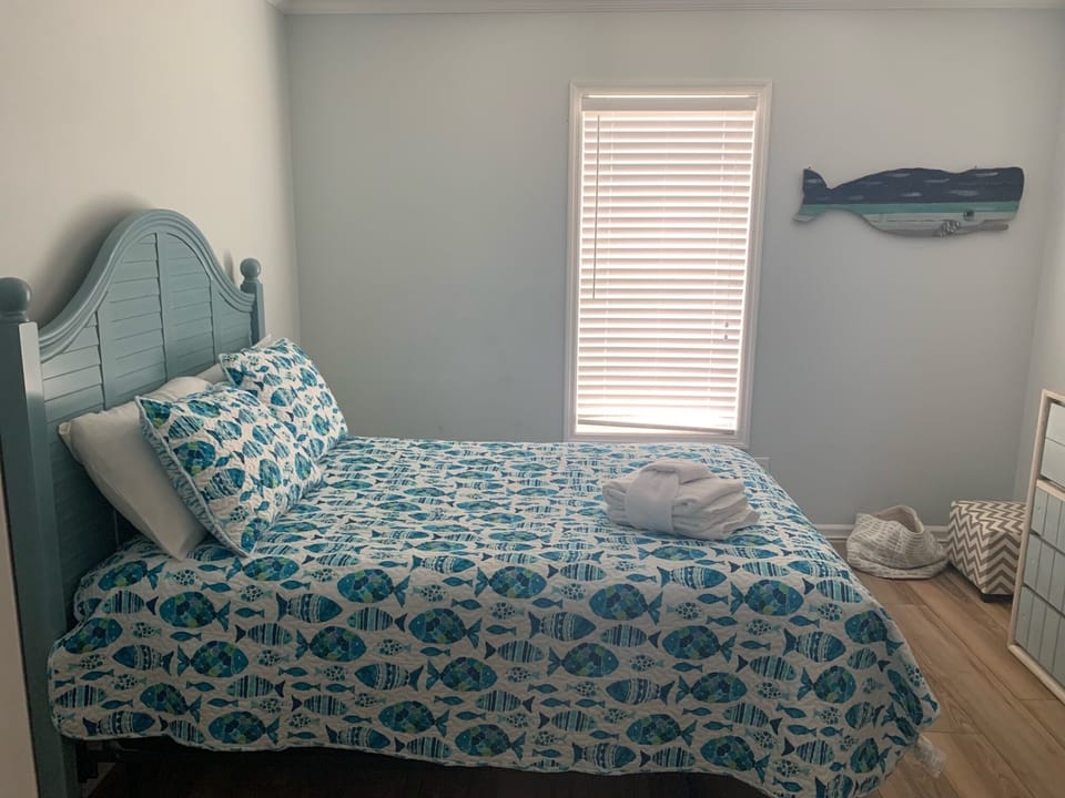Drift off in this coastal-themed bedroom where ocean-inspired bedding and charming whale decor create your perfect seaside retreat.