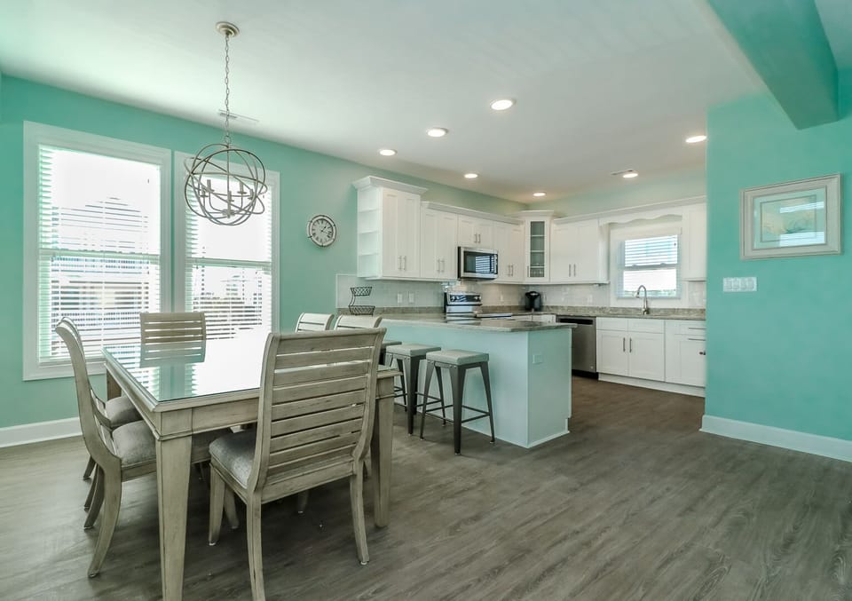 Gather around this bright, cheerful kitchen where coastal vibes meet modern convenience. You'll love cooking together in this spacious, well-equipped space.