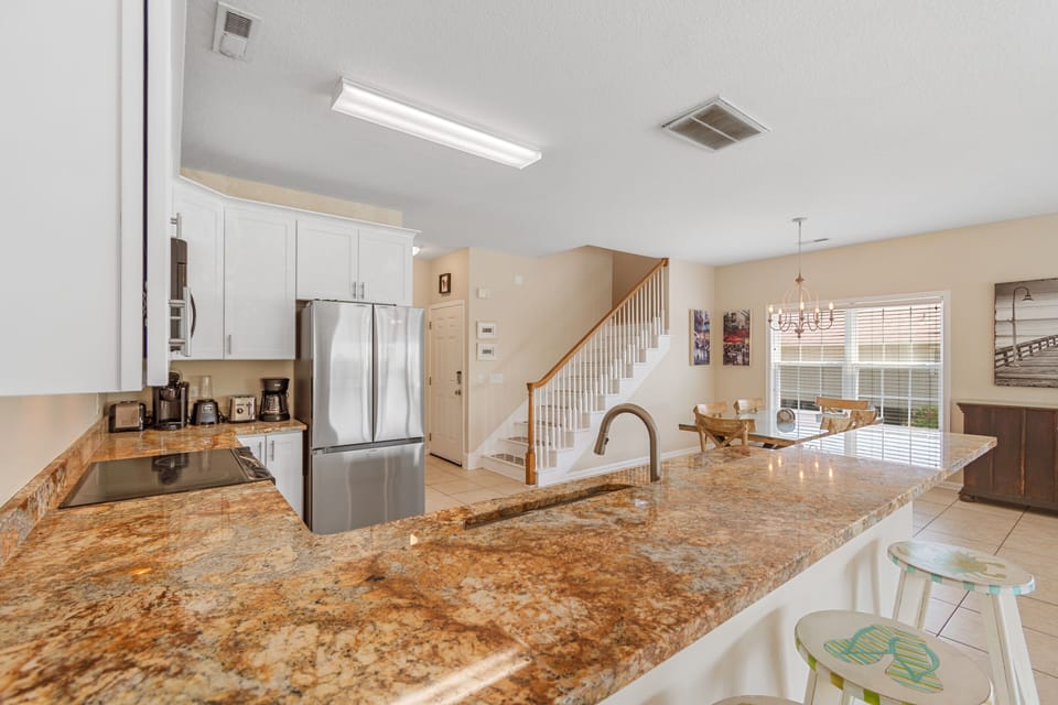 Your gourmet kitchen features granite countertops, stainless steel appliances, and an island perfect for morning coffee or family gatherings.