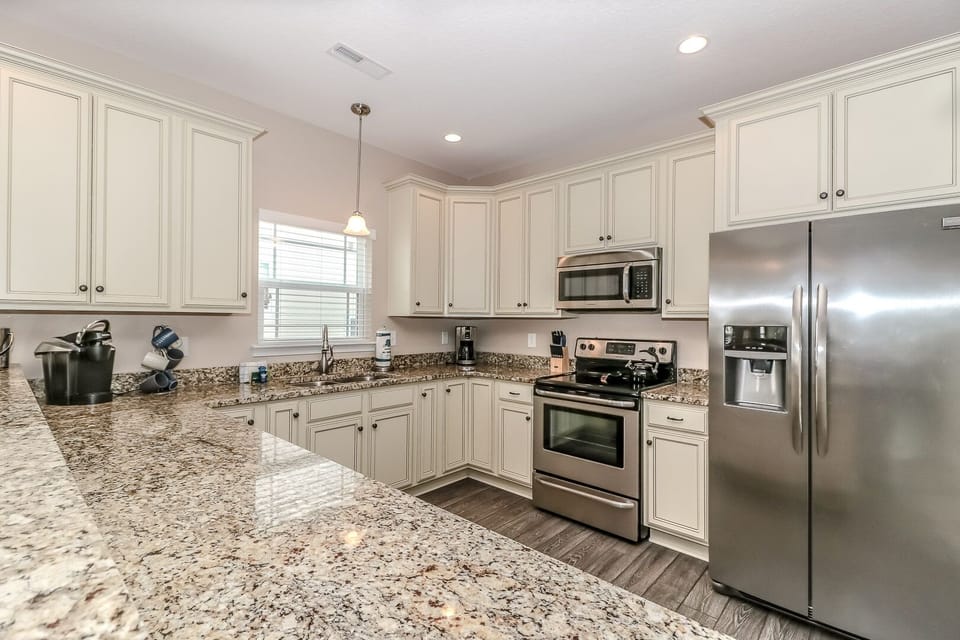 Your fully equipped kitchen features granite countertops, stainless steel appliances, and ample cabinet space for all your culinary adventures.