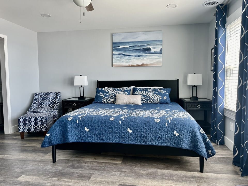 Drift off in your coastal-themed bedroom, where ocean blues and elegant furnishings create the perfect seaside sanctuary for restful nights.