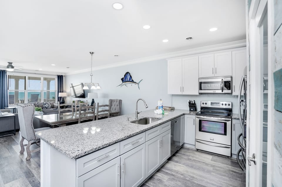 Your modern kitchen features granite countertops, stainless steel appliances, and seamlessly flows into the dining and living areas for effortless entertaining.