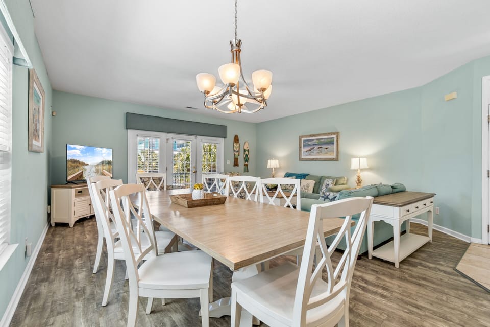 Gather your group around this spacious dining table for memorable meals, with coastal charm and elegant lighting setting the perfect mood.