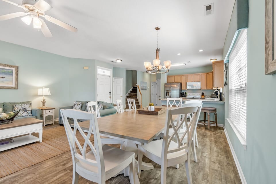 Gather around this inviting dining table where coastal charm meets comfort, creating the perfect spot for your memorable meals together.
