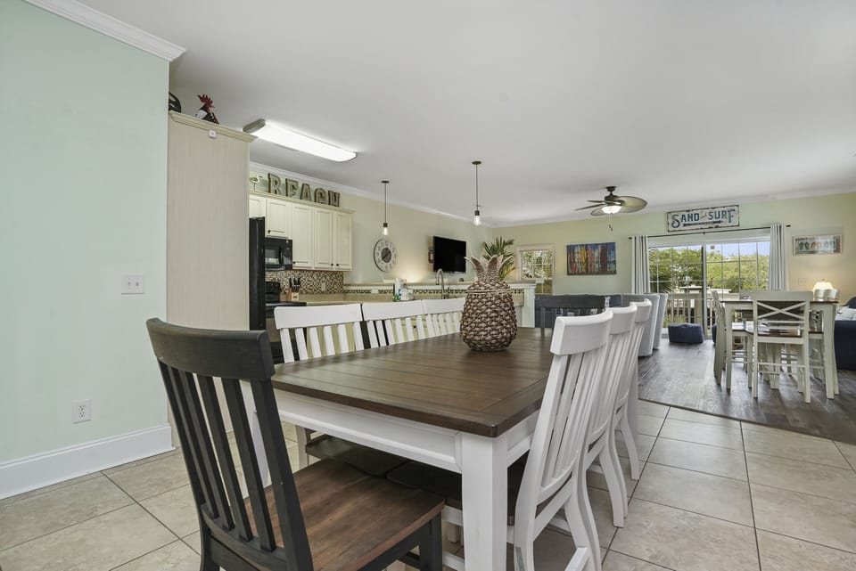 Gather around this spacious dining table where your family creates lasting vacation memories over home-cooked meals in your bright, open-concept retreat.