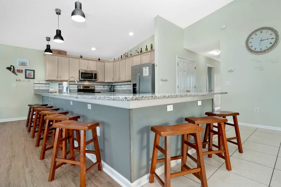 Gather around this spacious kitchen island with granite counters and modern appliances for memorable meals together.