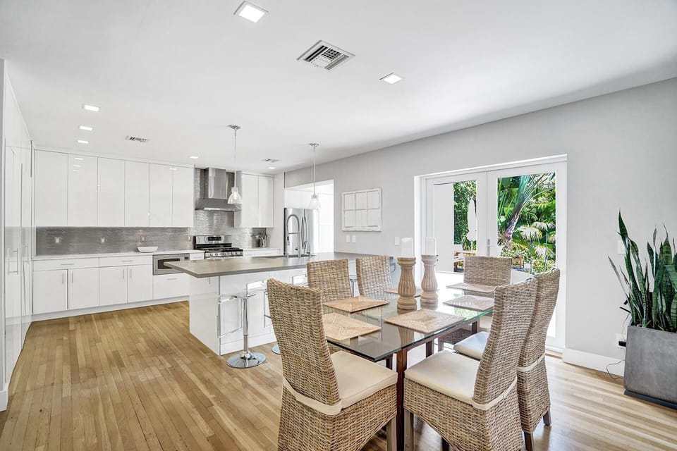 Dining area, kitchen peninsula with concrete countertop, and kitchen area.