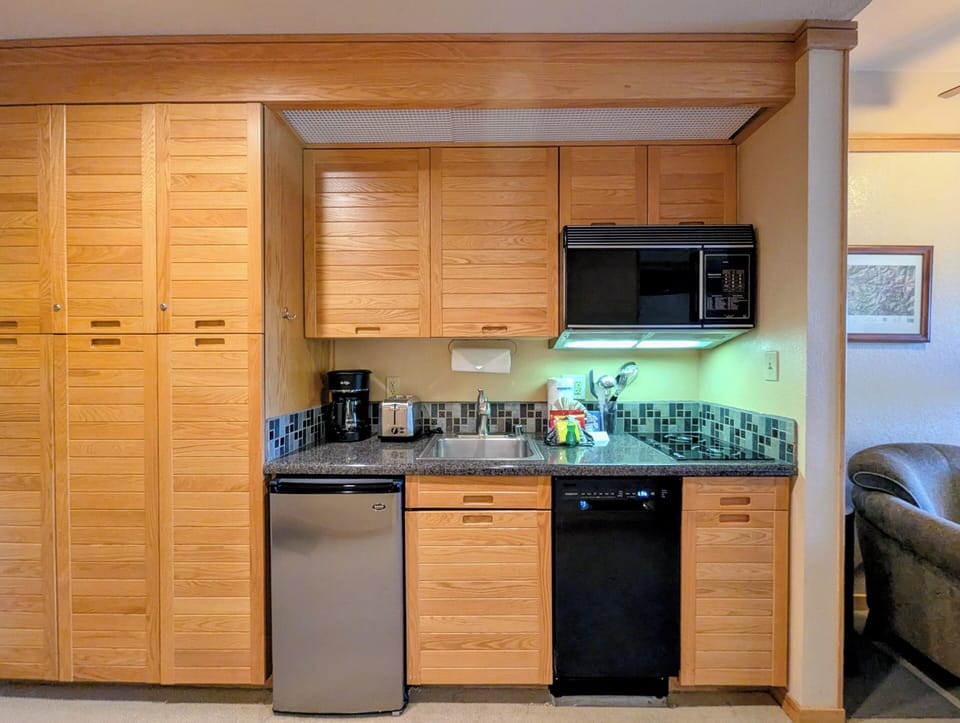 Your fully equipped kitchen features warm wood cabinetry, granite counters, and modern appliances for convenient meal prep.