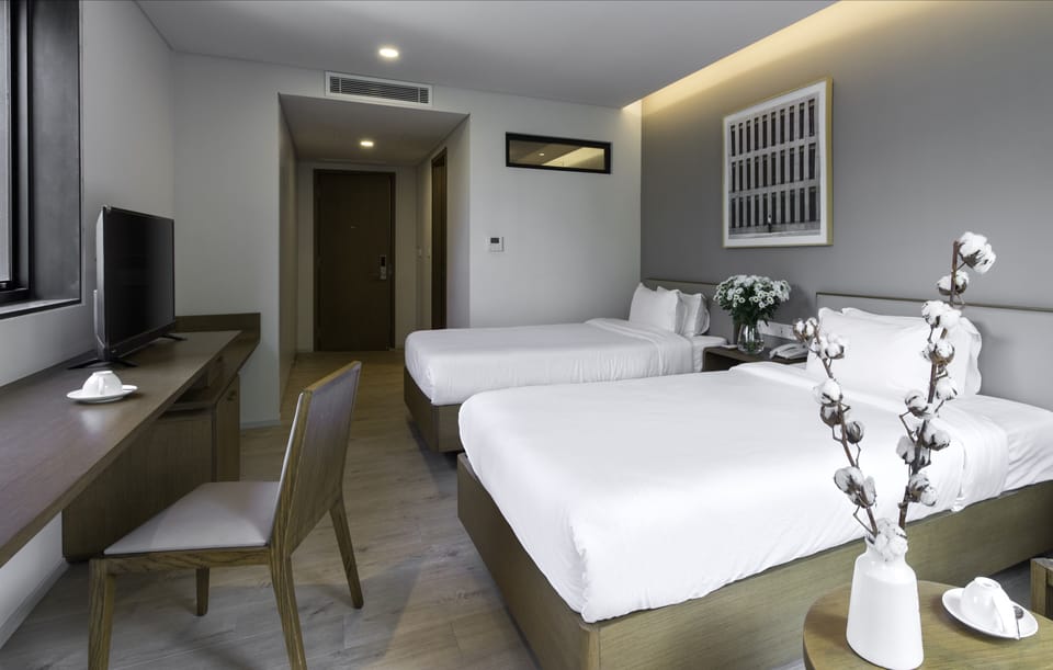 Deluxe Twin Room, 2 Twin Beds, Garden View | Minibar, in-room safe, soundproofing, iron/ironing board