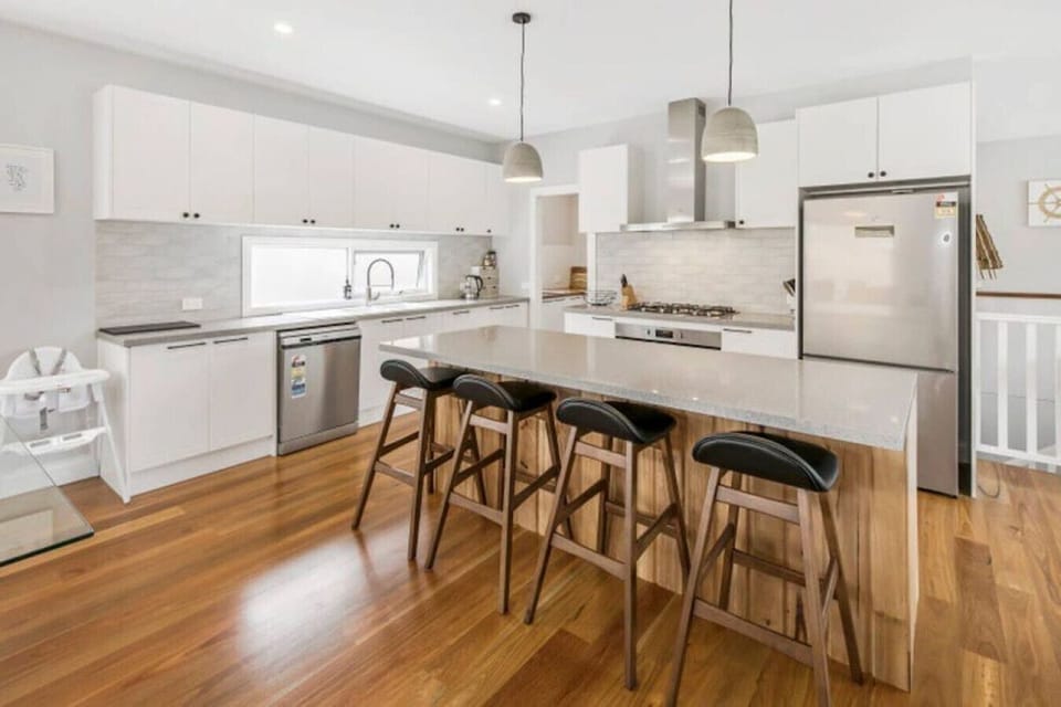 Fully-equipped kitchen with additional bench seating and butler`s pantry.
