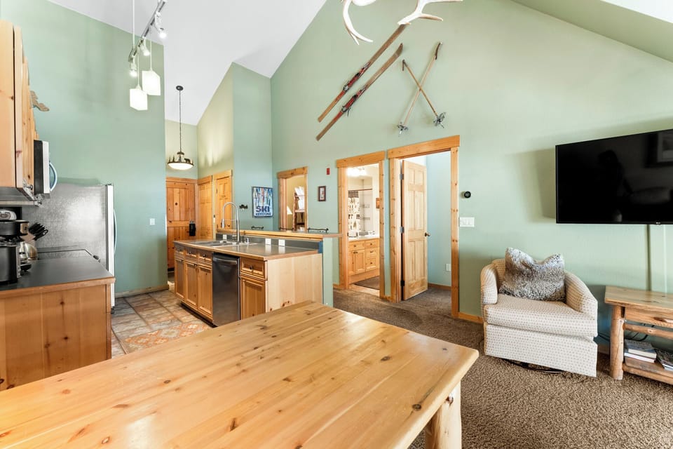 Relax in your spacious open-concept retreat with vaulted ceilings, rustic wood touches, and cozy living area perfect for mountain getaways.