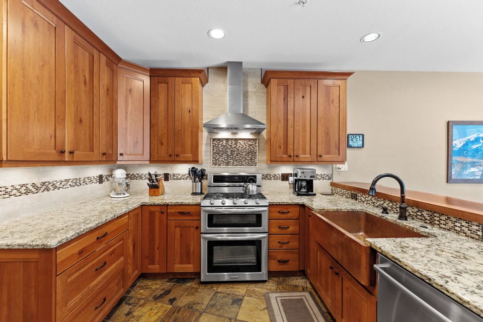 Your fully equipped gourmet kitchen features granite countertops, cherry cabinets, and stainless steel appliances—perfect for creating memorable meals during your stay.