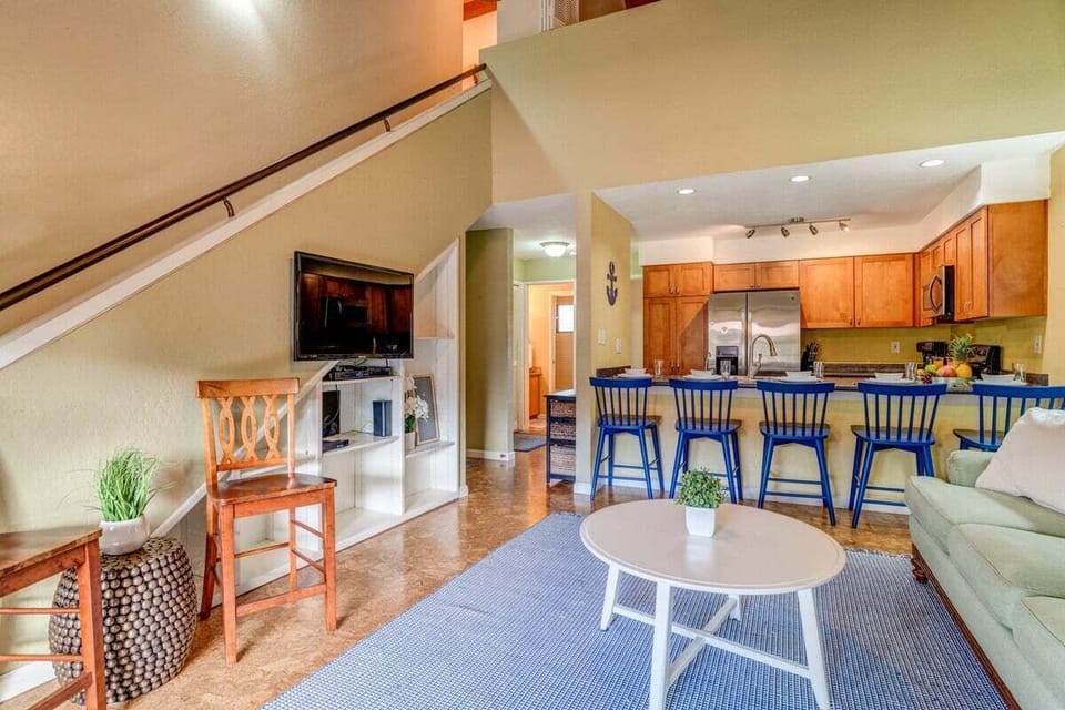 Bright living room with spacious seating, coastal décor, and a welcoming, open layout.