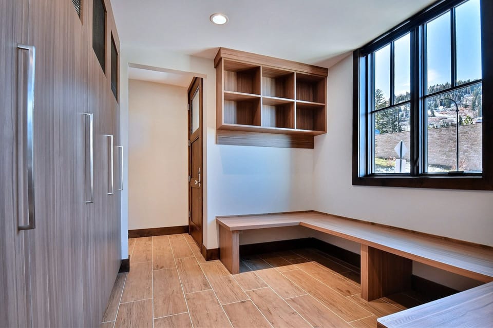 Huge mudroom with lockers, boot dryers and benches to store everything