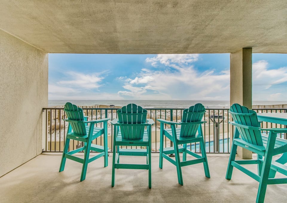 Balcony with outdoor dining table and Gulf views at Wind Drift Orange Beach