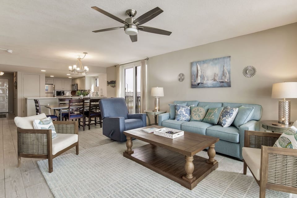 Open-concept living room with Gulf views at Wind Drift Orange Beach