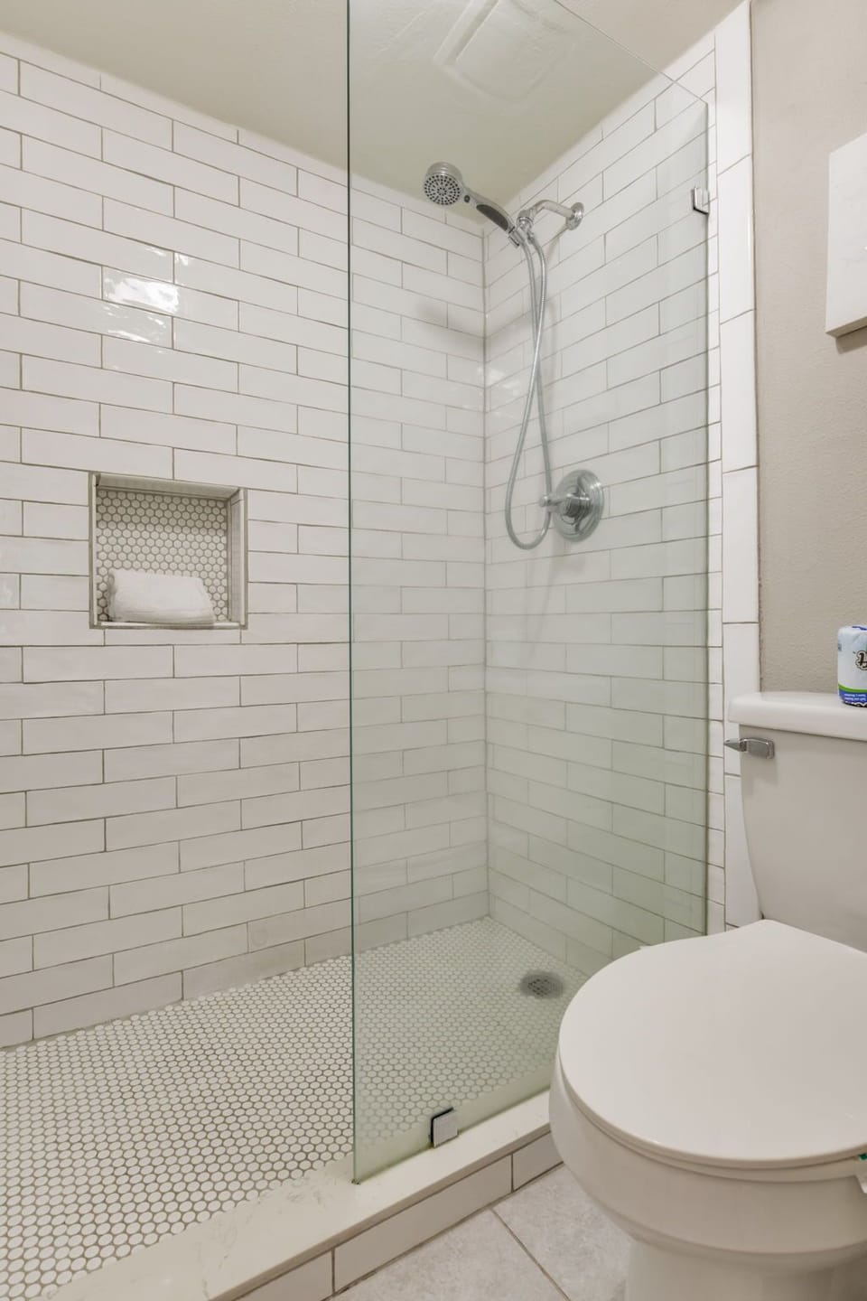 Primary bathroom with walk-in tiled shower at Wind Drift Orange Beach