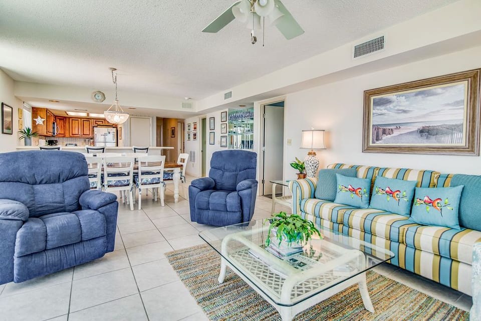 Living room with floor-to-ceiling Gulf views at Wind Drift Orange Beach corner unit