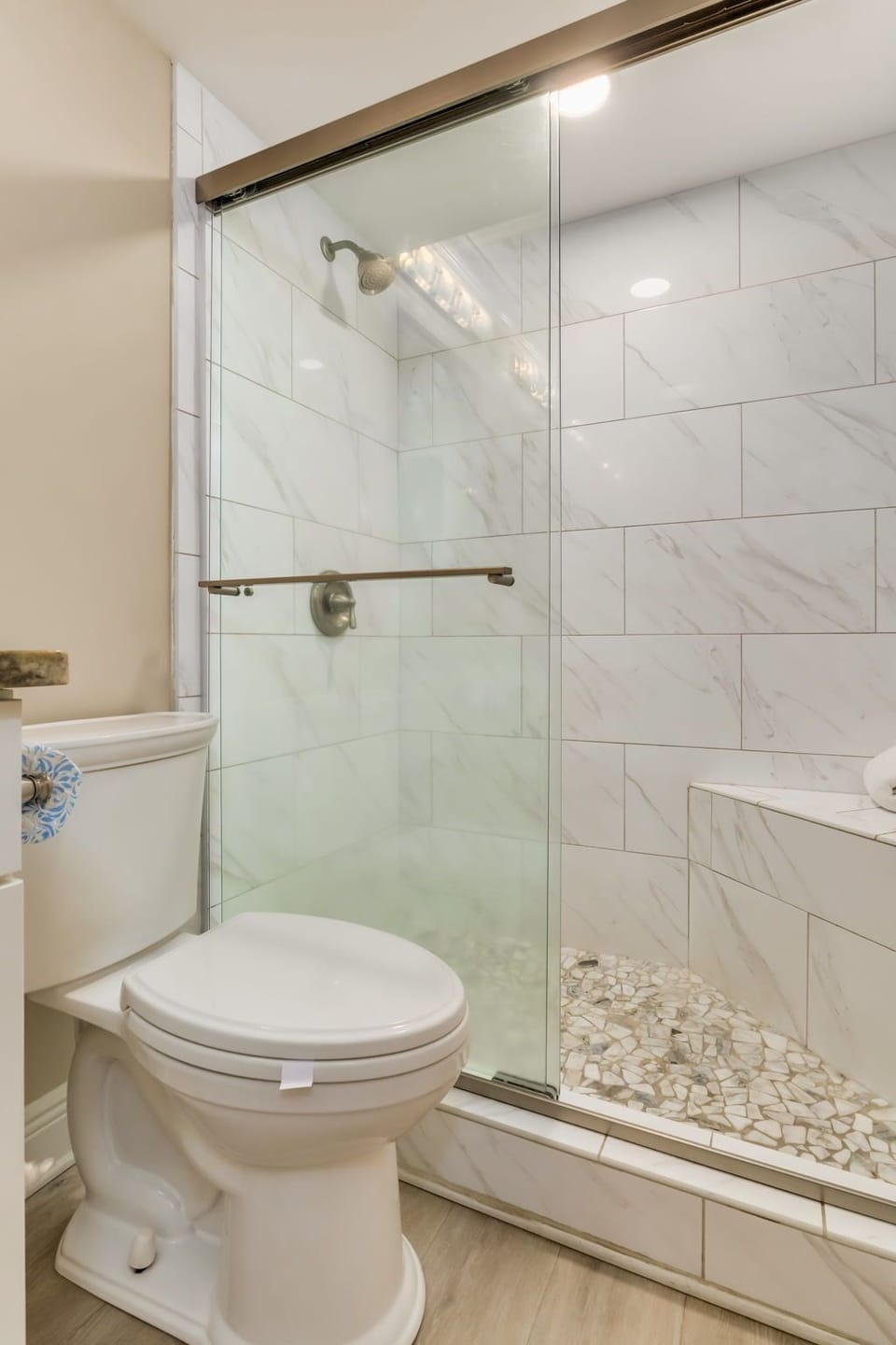 Primary bathroom with walk-in tiled shower at Wind Drift Orange Beach