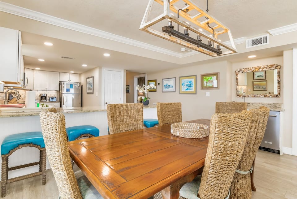 Dining table and kitchen island at Wind Drift Orange Beach 3-bedroom condo