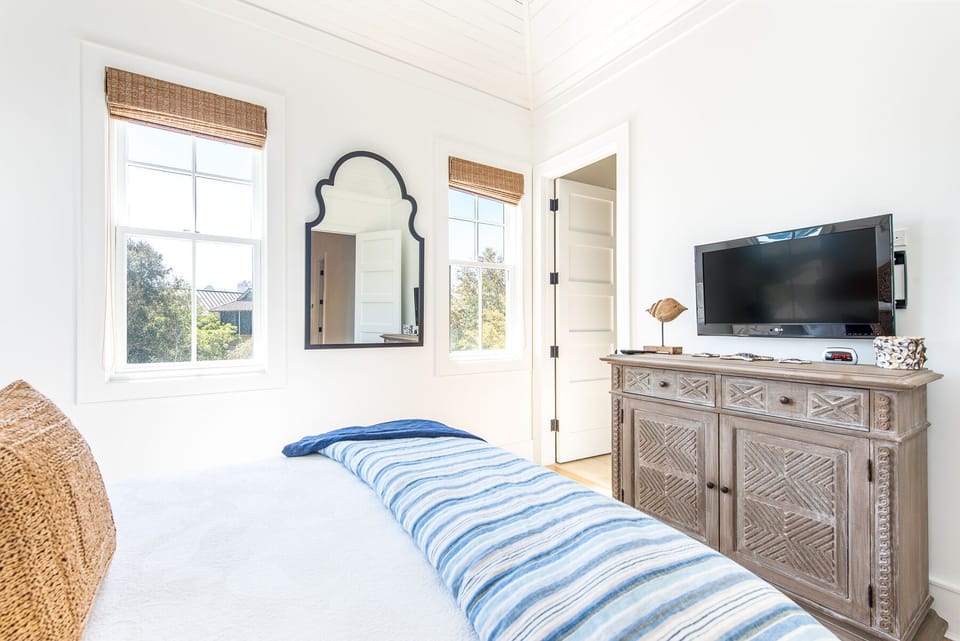 Large Bed, TV, Buffet Console, and Windows.