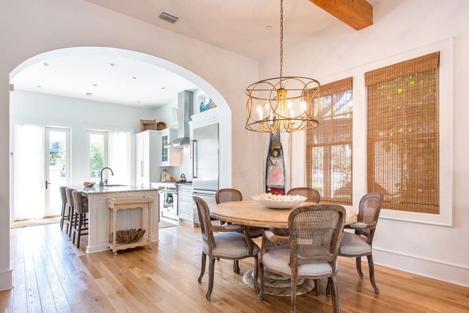 Dining Table, Chairs, Windows, and Kitchen with Island.