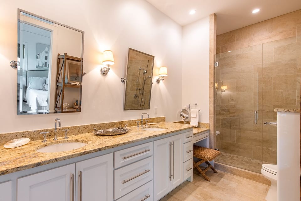 Double Sink Vanity, Mirrors, Walk-In Shower, and Toilet.