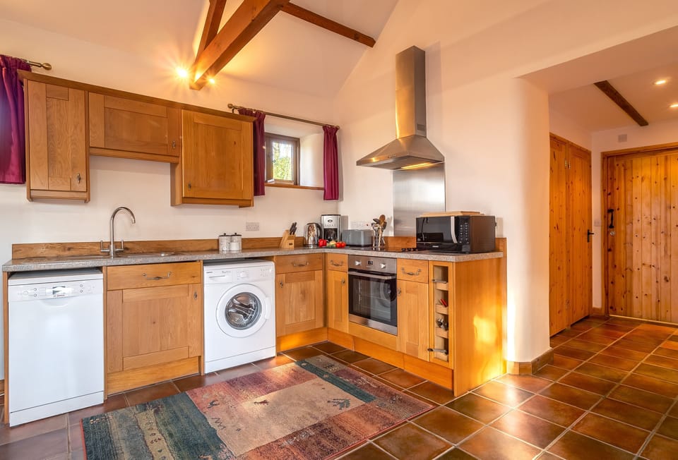 Church Close Cottage, Cusgarne. Ground floor: Kitchen with an oven and hob, dishwasher, microwave, fridge, freezer and washing machine