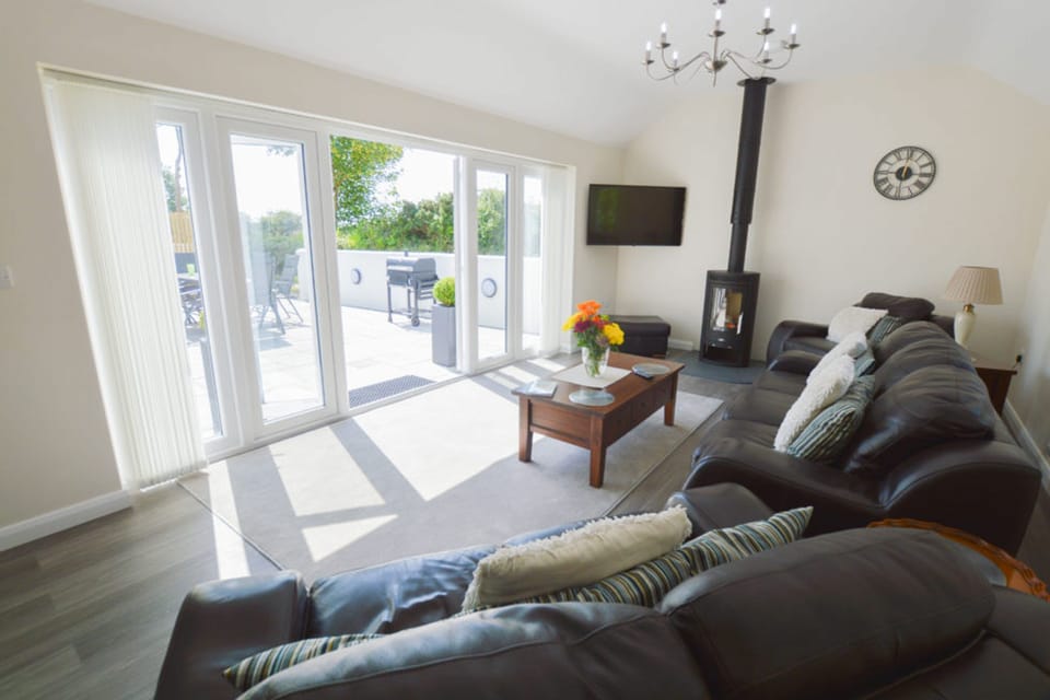 Sunnyside Barn, Truro. Ground floor: Look over the patio and stunning countryside views from the lounge