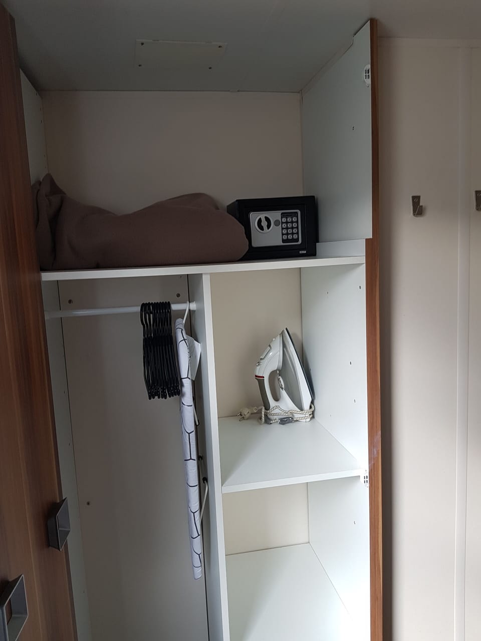 Wardrobe in the master bedroom - safe, iron and ironing board

