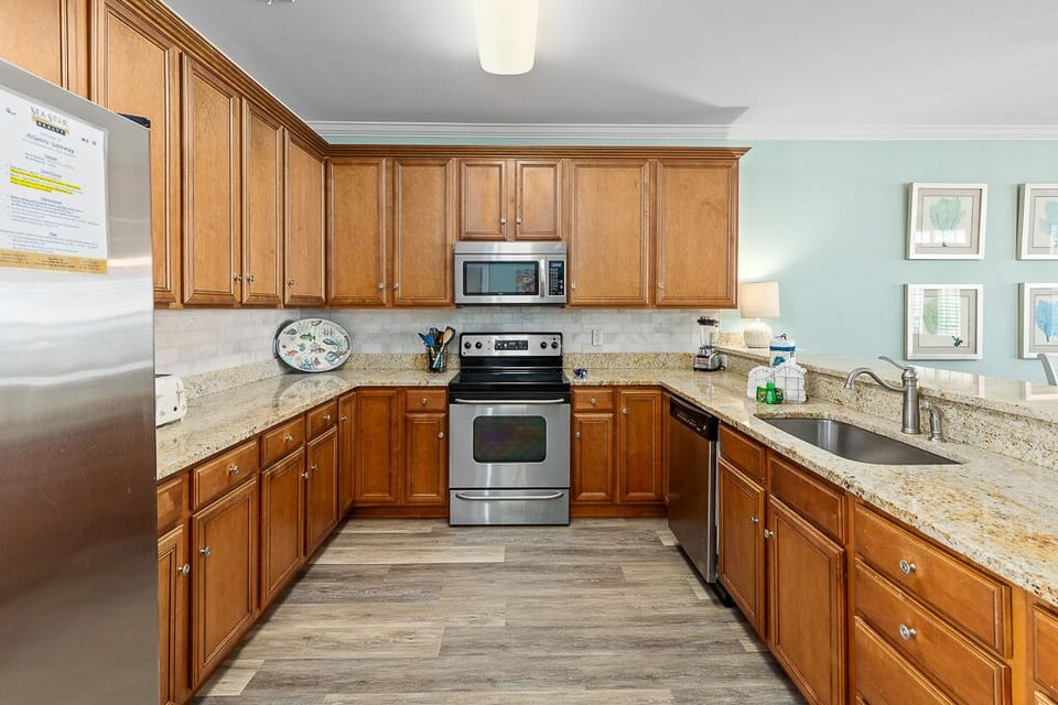 Your fully equipped kitchen offers granite countertops, stainless steel appliances, and warm wood cabinetry for all your culinary adventures.