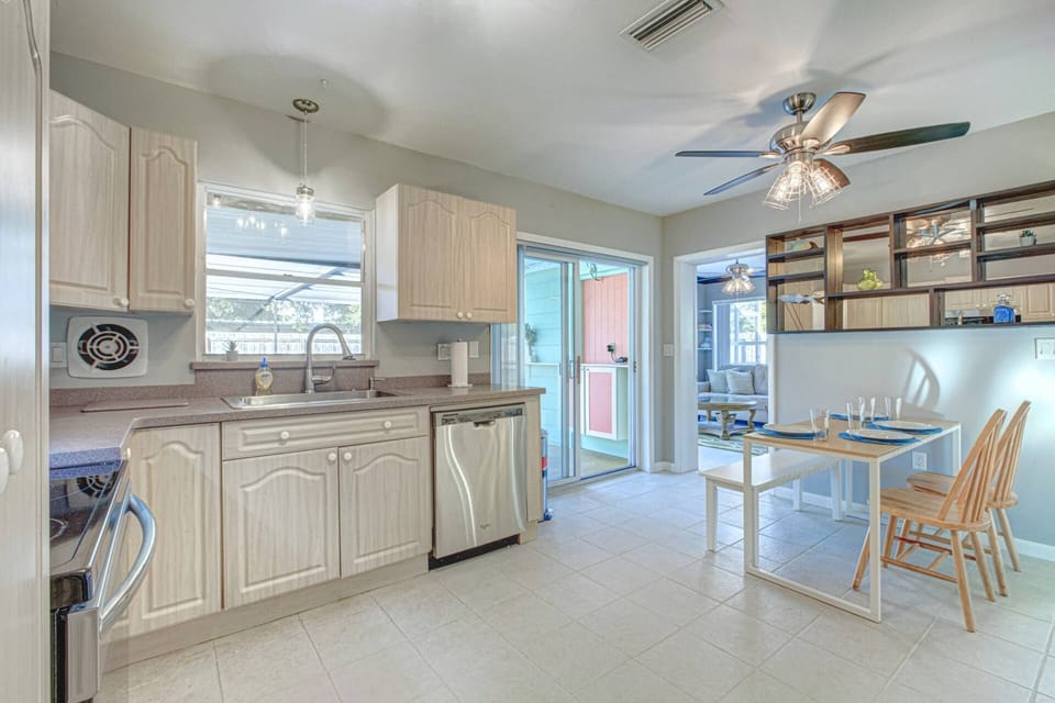 Large kitchen with stainless appliances and solid natural stone counters.
