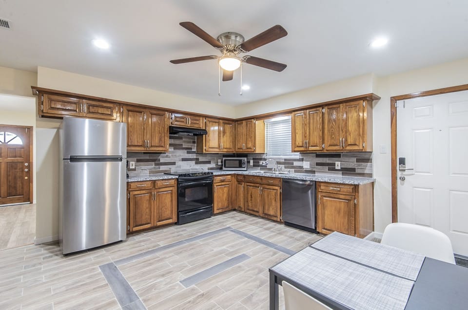 Kitchen with full size fridge, cooking range, dish washer, micro oven, toaster.