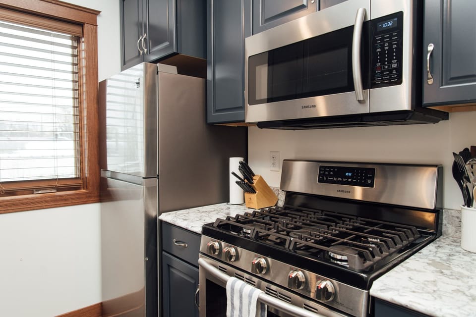 Fully equipped kitchen with pots, pans, and basic kitchen supplies. 