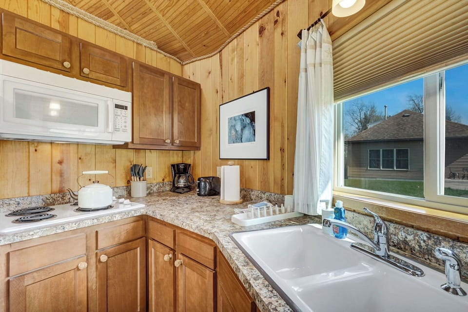 Microwave and stovetop (no oven) in a well-stocked kitchen (cooking appliances)