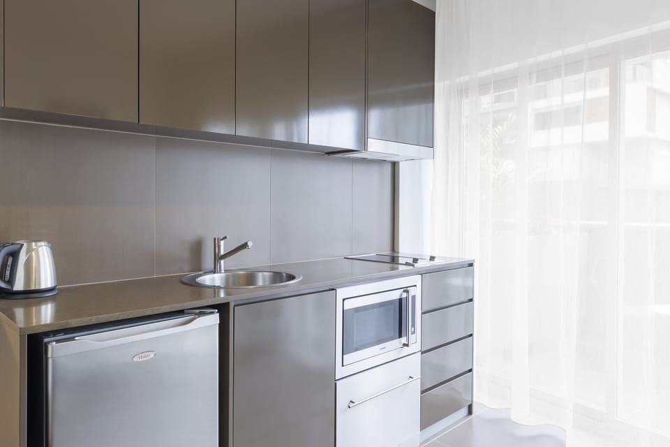 Studio Suite, 1 King Bed, Balcony | Private kitchen | Fridge, microwave, stovetop, dishwasher
