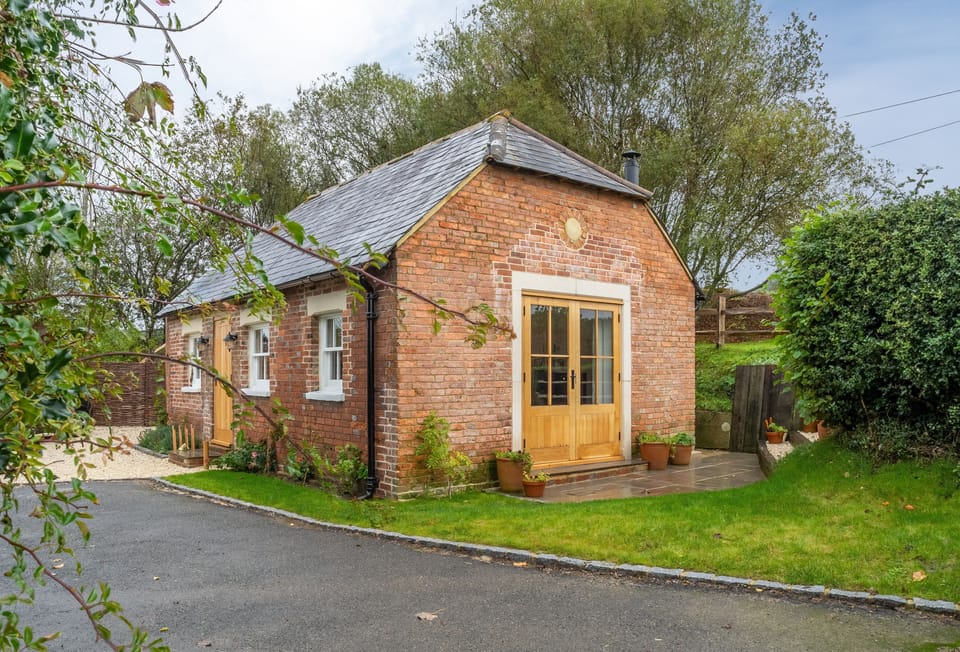 Inkpen Cottage is a detached, Grade II listed red brick building tucked away on Strawberry Hill Farm
