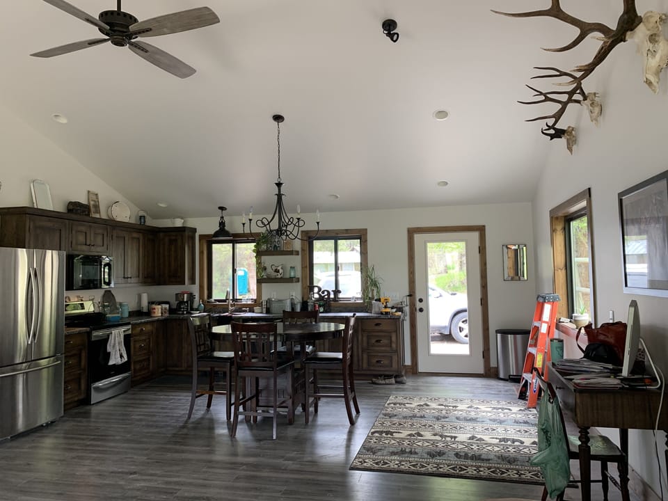 Sage open kitchen, dining room, living room with vaulted ceilings