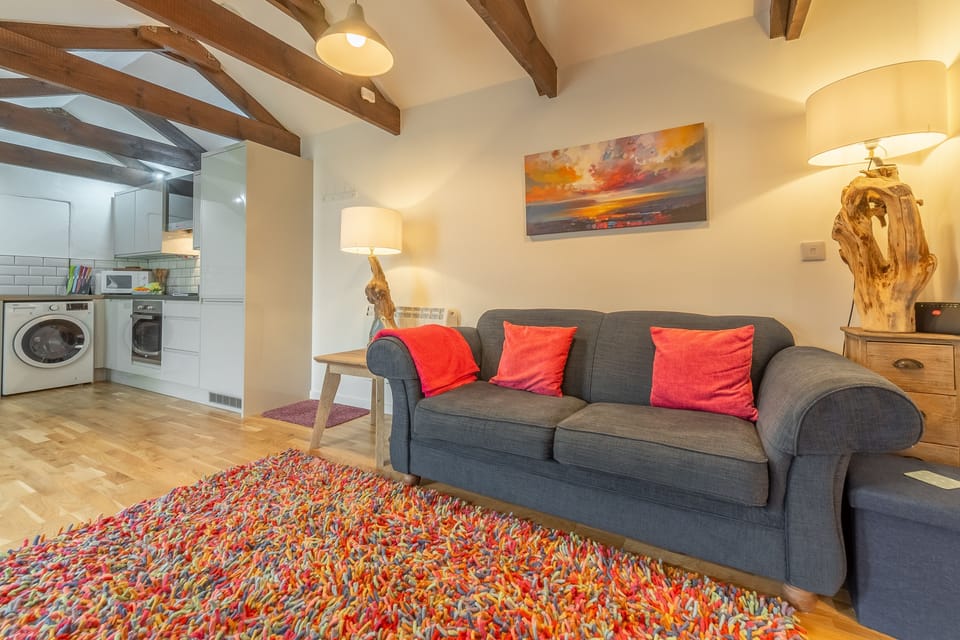 Potter's Barn, St Agnes. Open plan living area with sofa bed for one guest