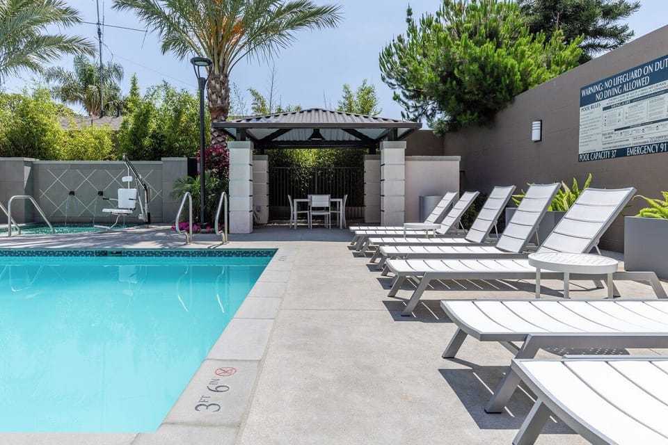 Resort pool deck with loungers and a shaded cabana